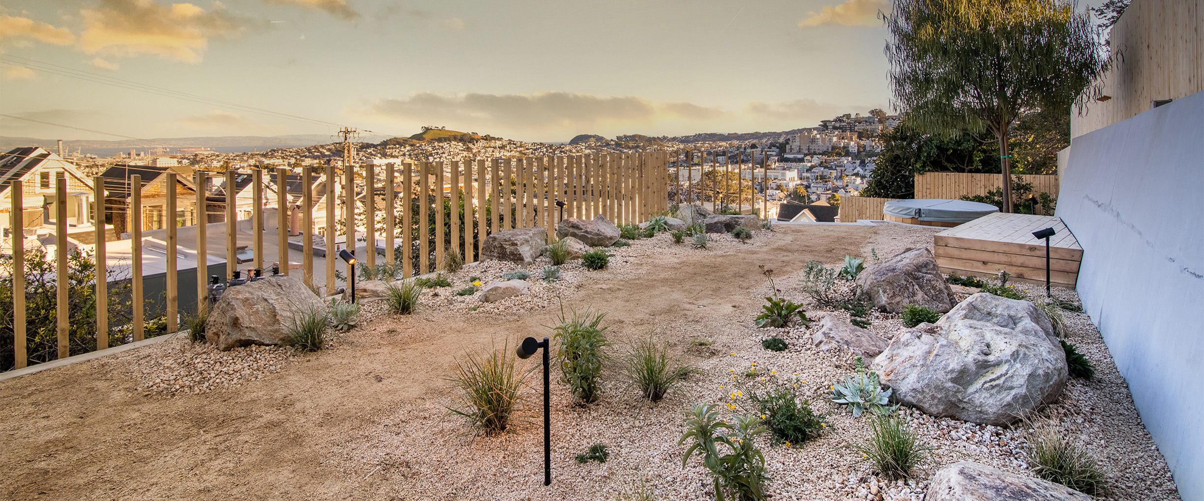 A desert inspired San Franciso multi-level patio on the hills with gravel walking paths, hot tub, and fire pit.