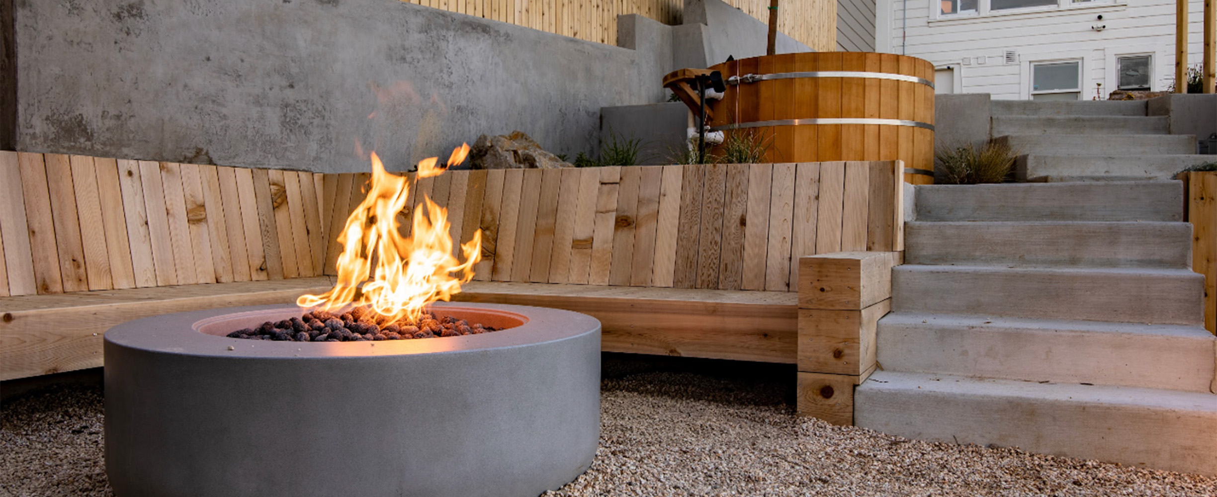 A gorgeous hot tub and modern fire pit in a hill hpouse patio with differenty levels i San Francisco